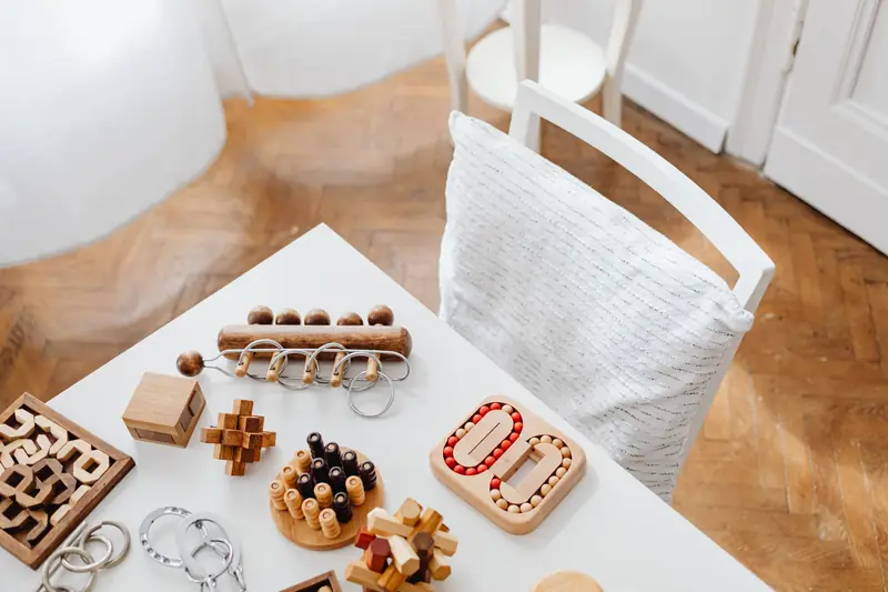 A collection of wooden puzzle toys arranged on a modern table in an indoor setting, perfect for encouraging intellectual play